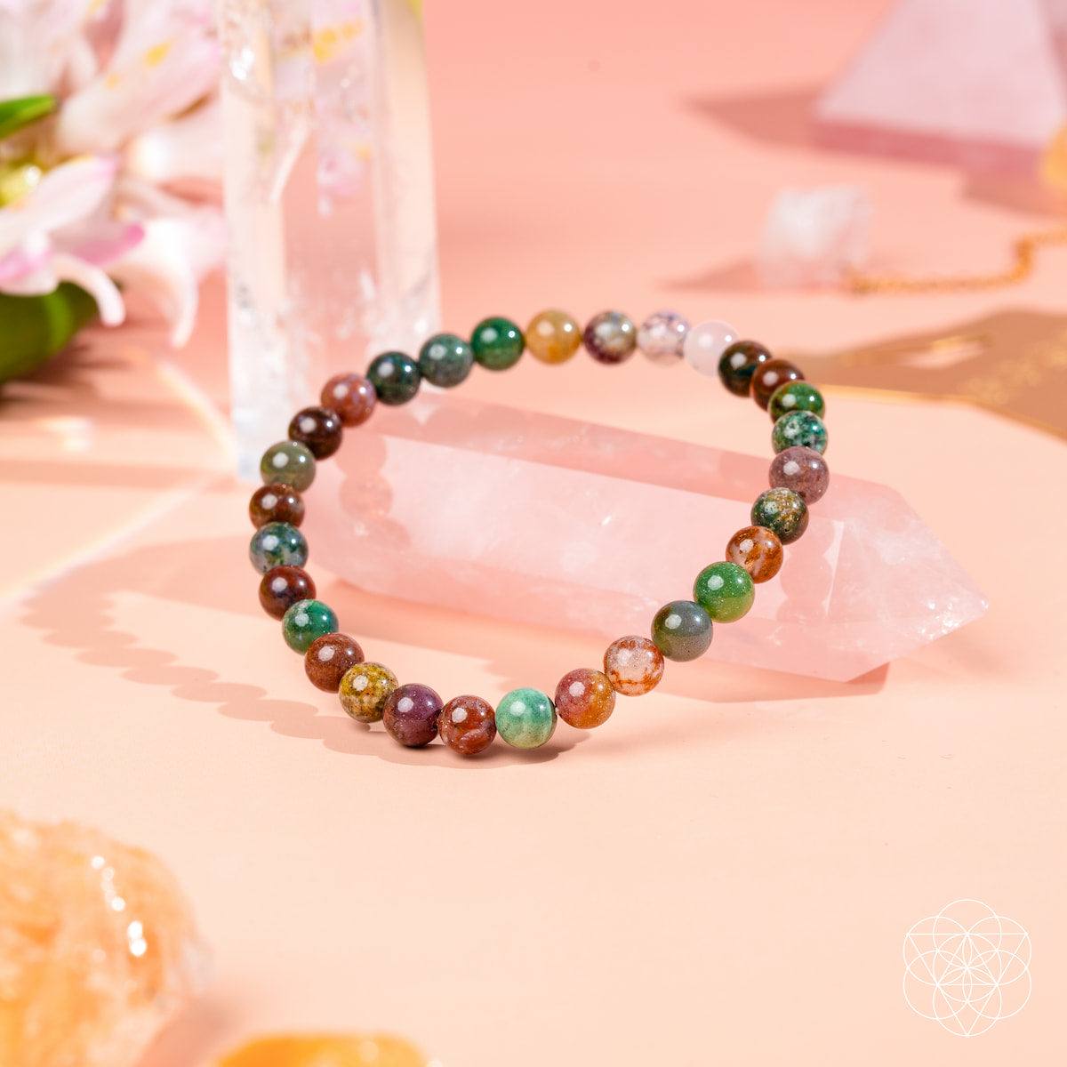 Energy Bracelet with glossy, multicoloured natural stone beads in varied green, brown, cream and red patterns.