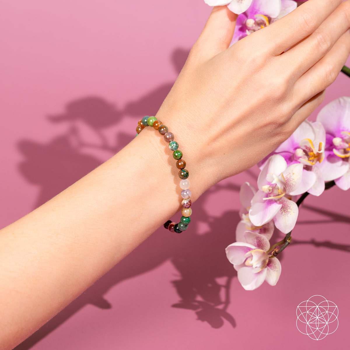 Energy Bracelet with small polished natural agate beads in mixed green, brown, pink, cream, and purple hues, strung on elastic.